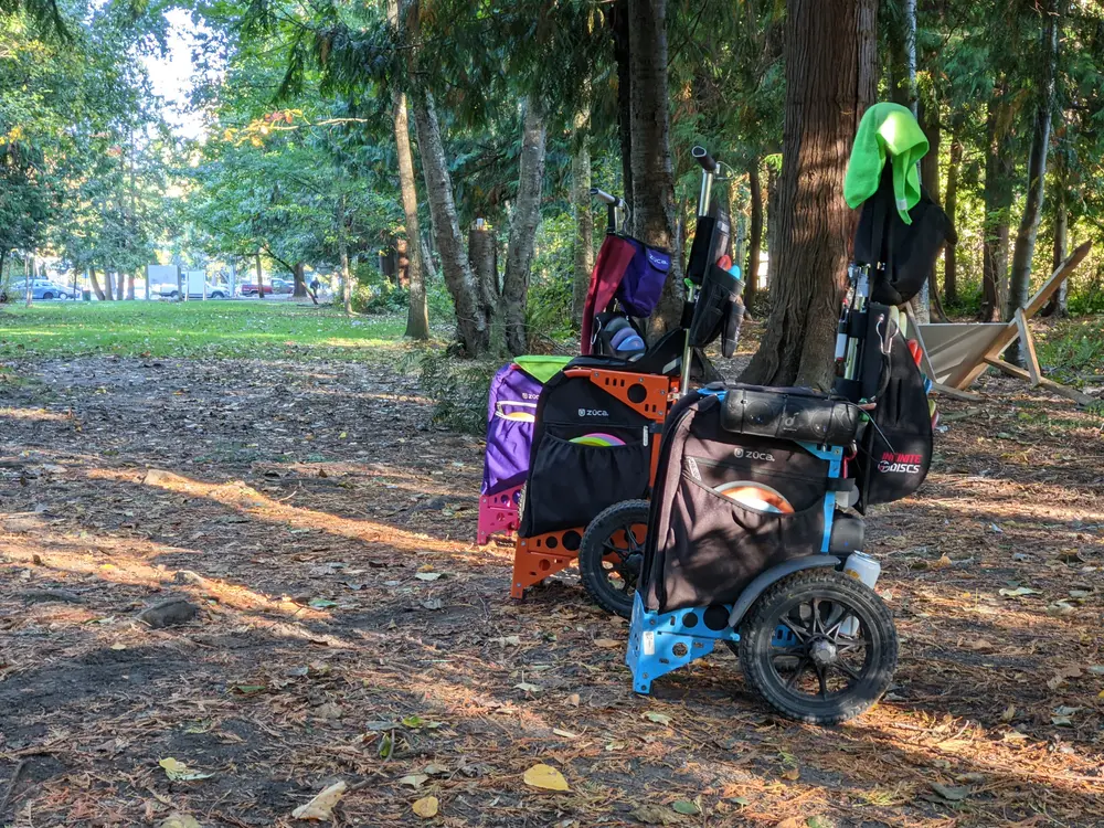 Disc golf carts resting beneath the trees at Winskill